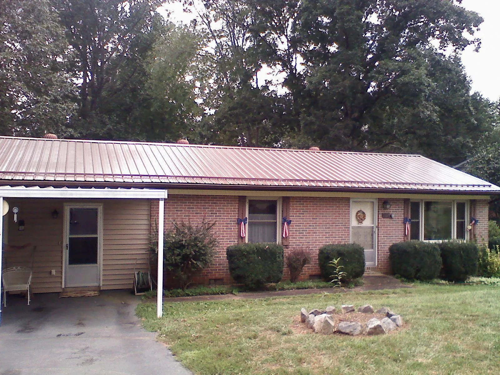 Bronze metal roof and carport on a brick ranch home — Roof Repair work by our crew in Burkittsville