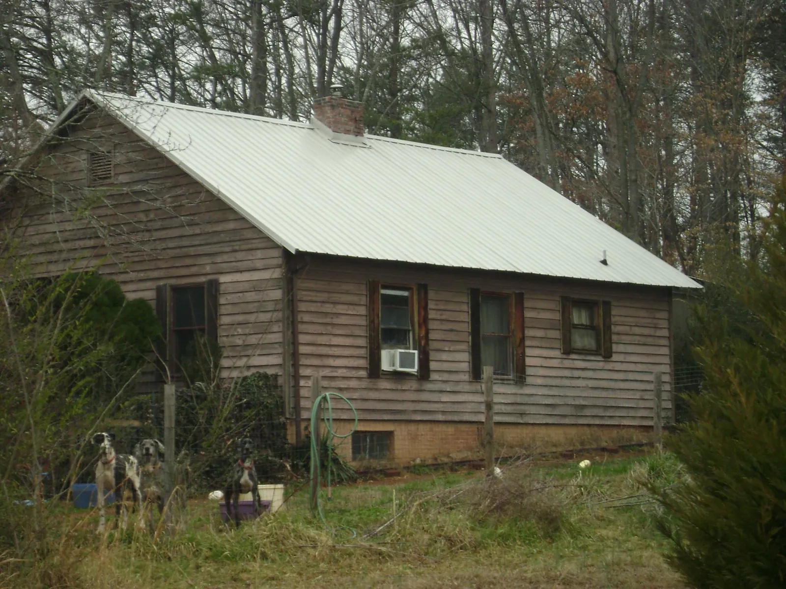 White metal roof on an old wood sided farmhouse, from a Metal Roof Installation job in Burkittsville